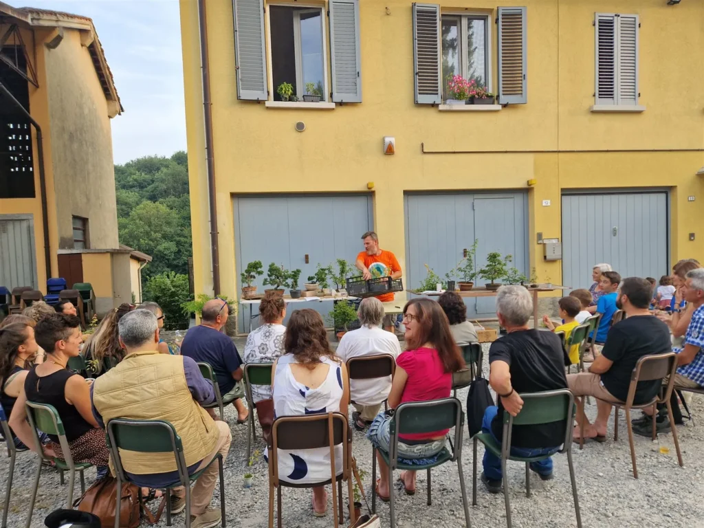 Luca presenting bonsai to a large outdoor audience